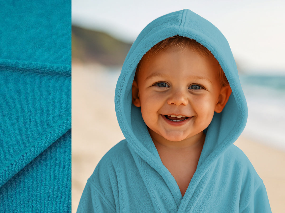Turquoise towel hoodie on toddler at beach – Bean Design