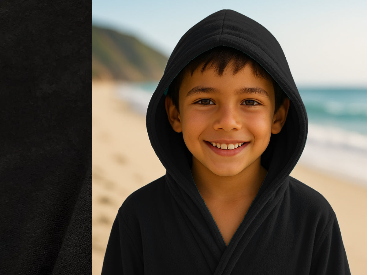 Black towel hoodie on kid at beach – Bean Design